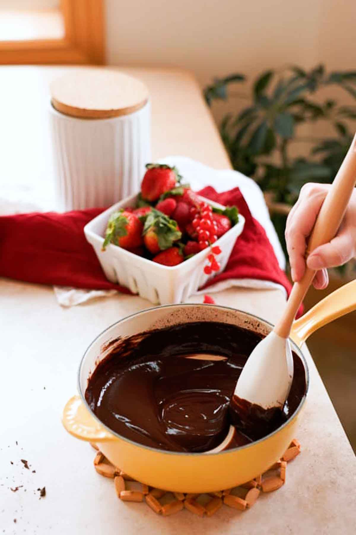 stirring melted chocolate and wine in small saucepan with spatula