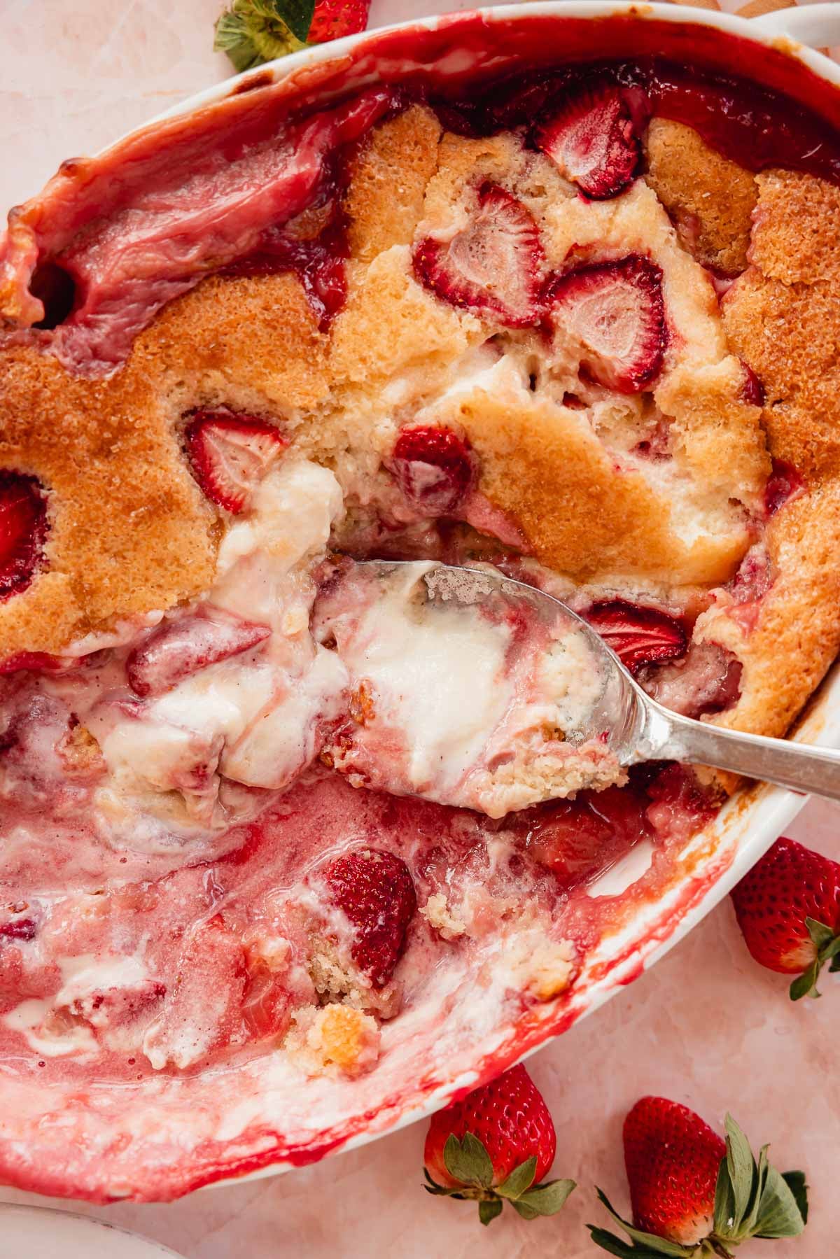 closeup of strawberry and cheesecake filling with cobbler topping