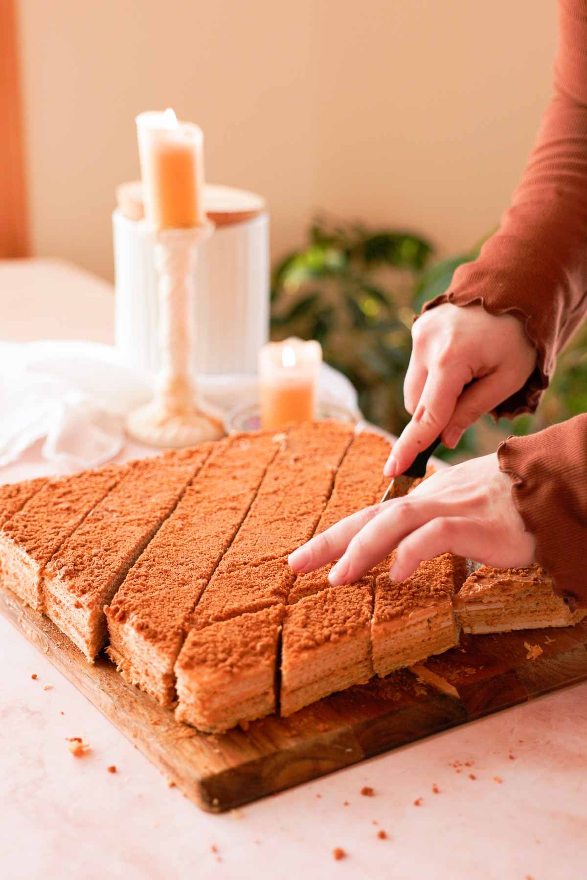 cutting dulce de leche waffle cake into diamond pieces