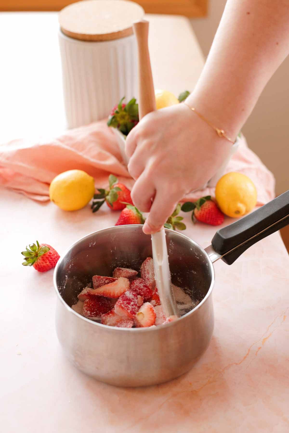 mixing strawberries, sugar, and cornstarch in a saucepan
