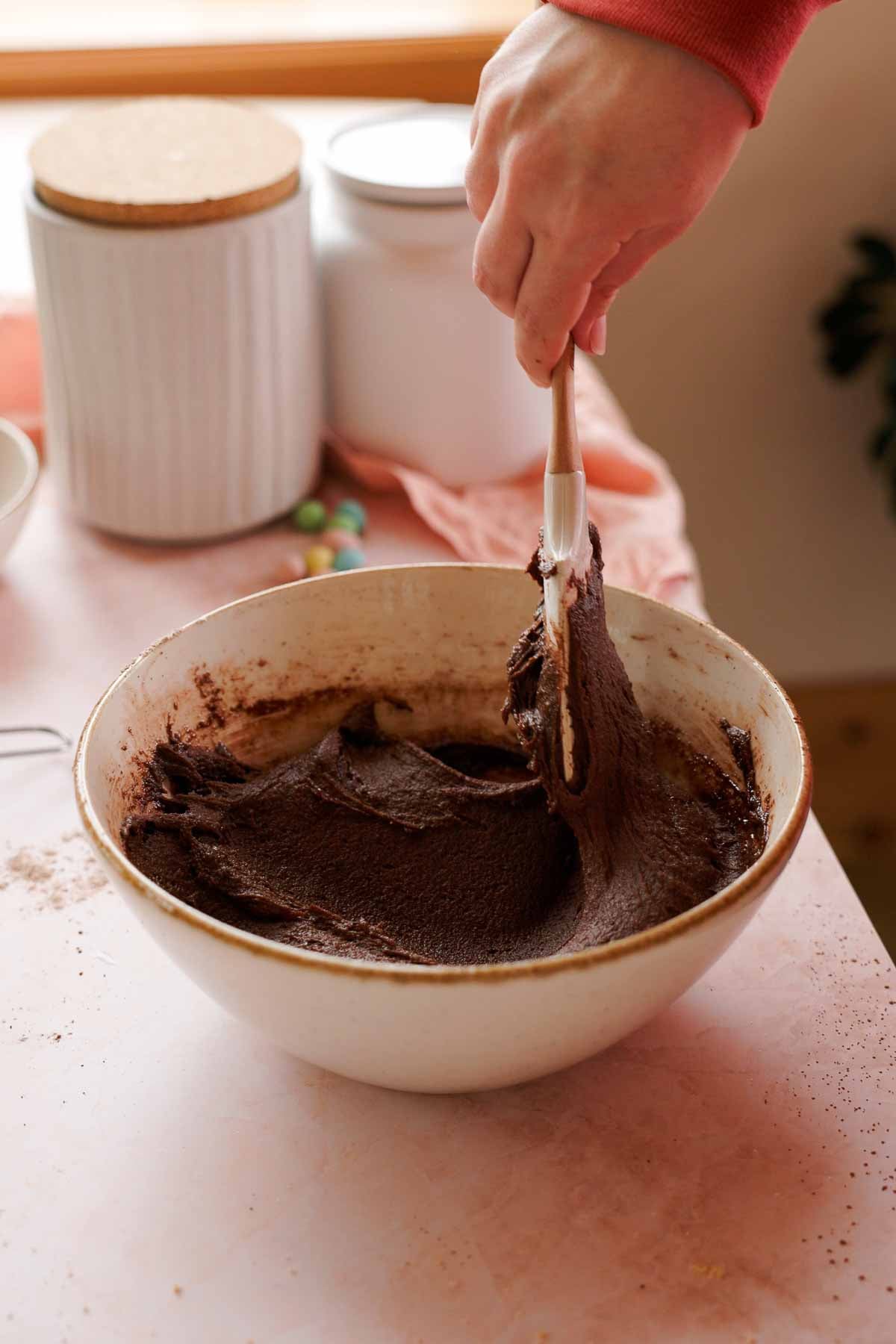 mixing mini egg cookie dough with spatula in large bowl