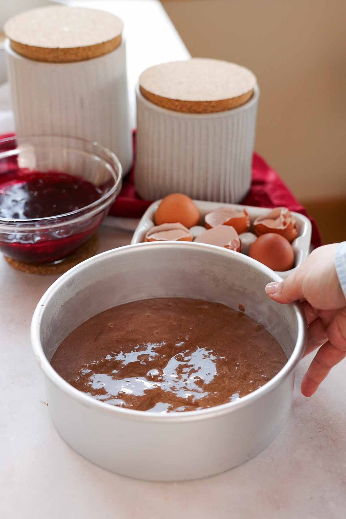 chocolate sponge cake batter in aluminum cake pan