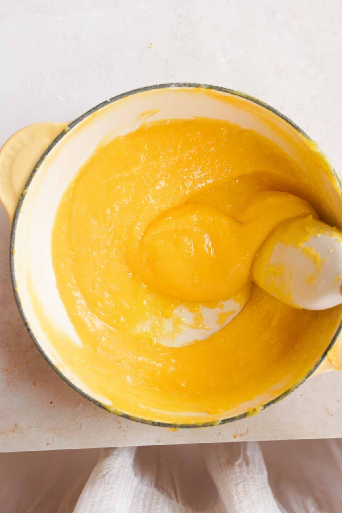 cooking lemon pie filling in saucepan