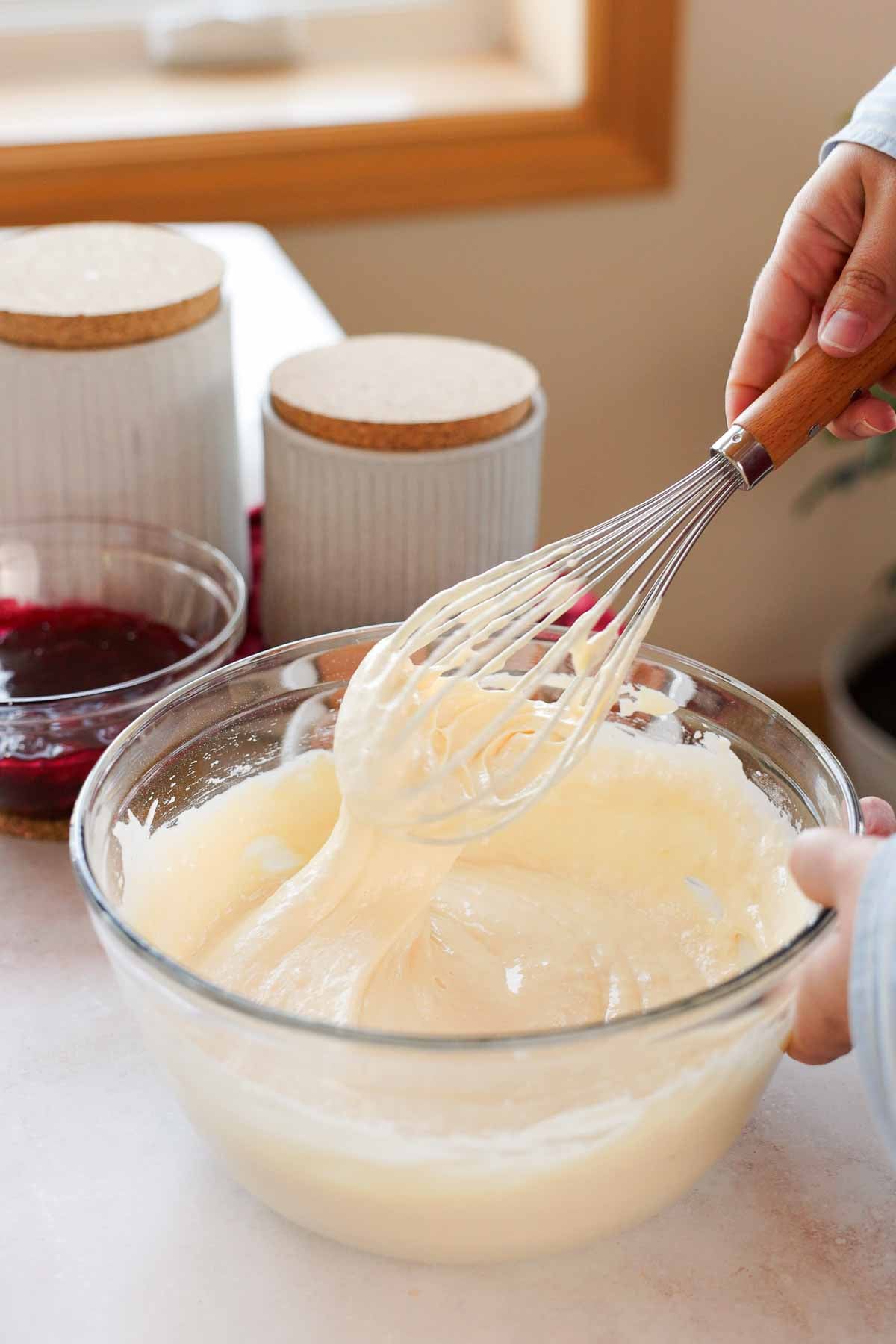 folding flour into vanilla sponge cake batter with wire whisk