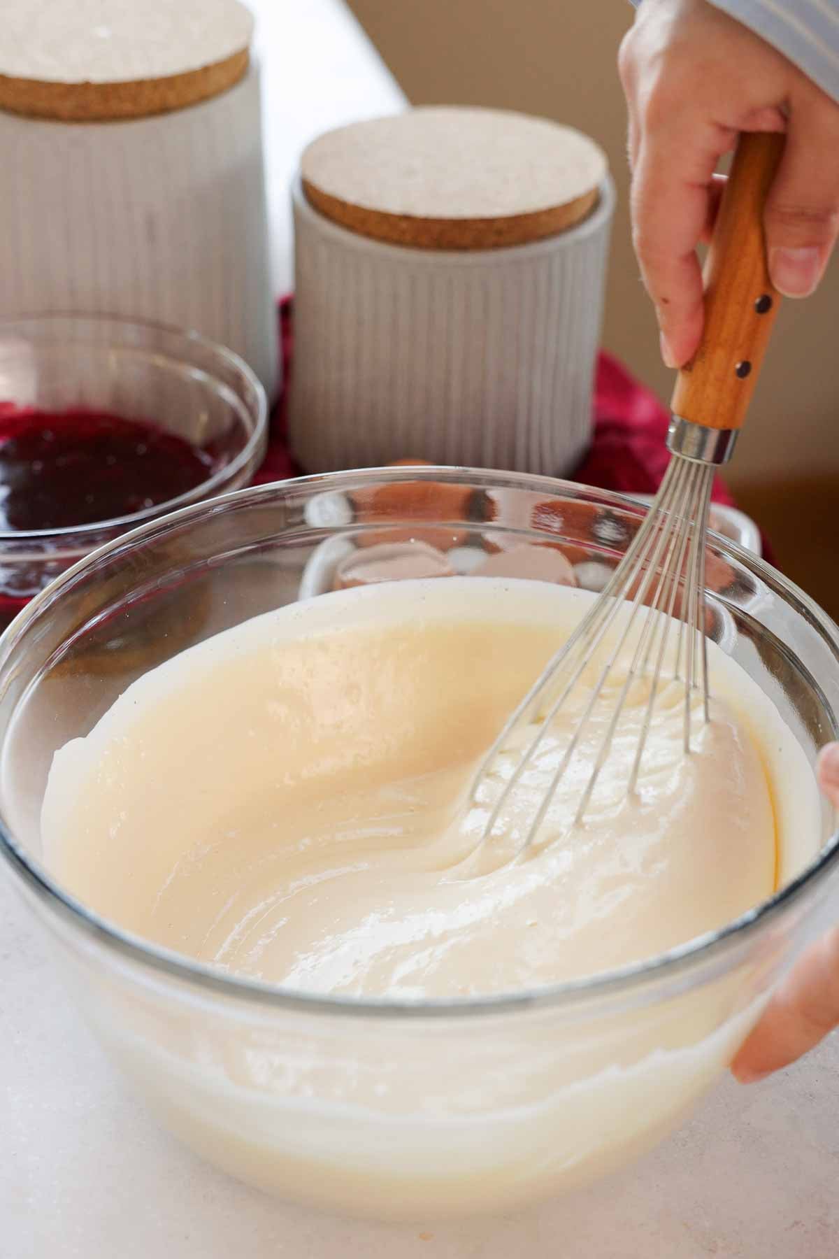 folding sour cream into whipped eggs with a wire whisk