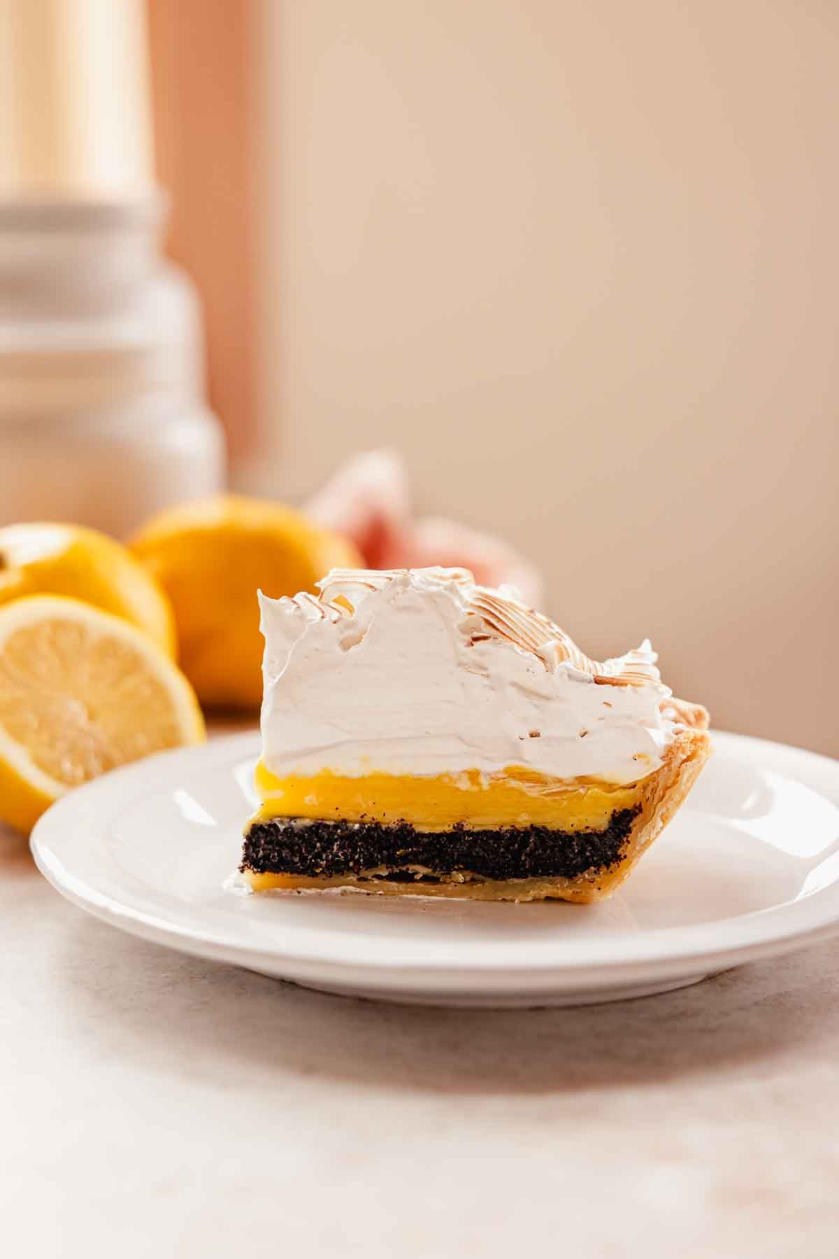 slice of pie with lemon filling, poppy seed filling, and thick meringue