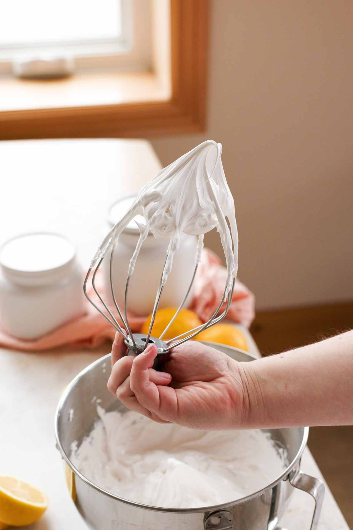lifting whisk out of meringue to show when to stop mixing