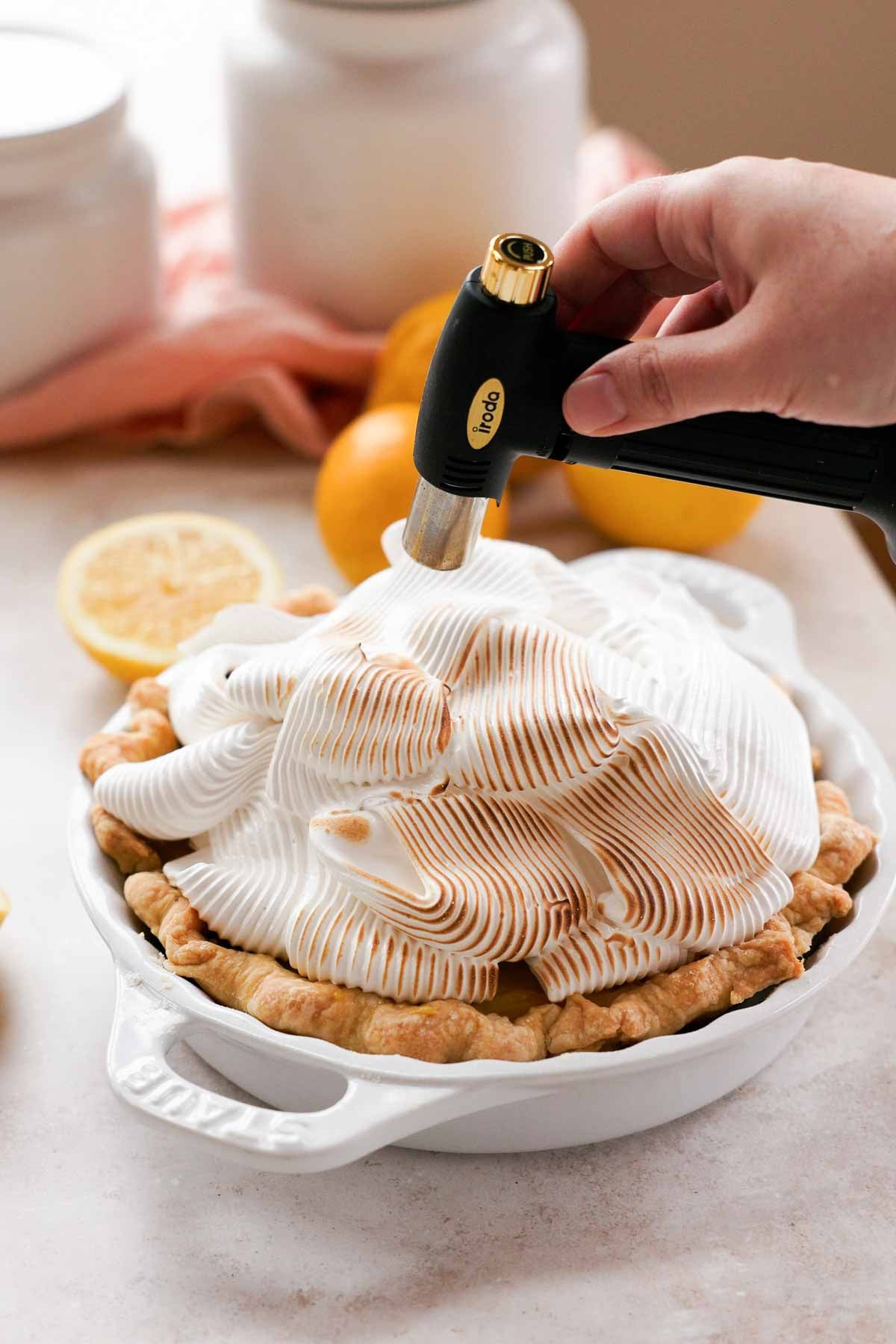 toasting piped meringue with a torch