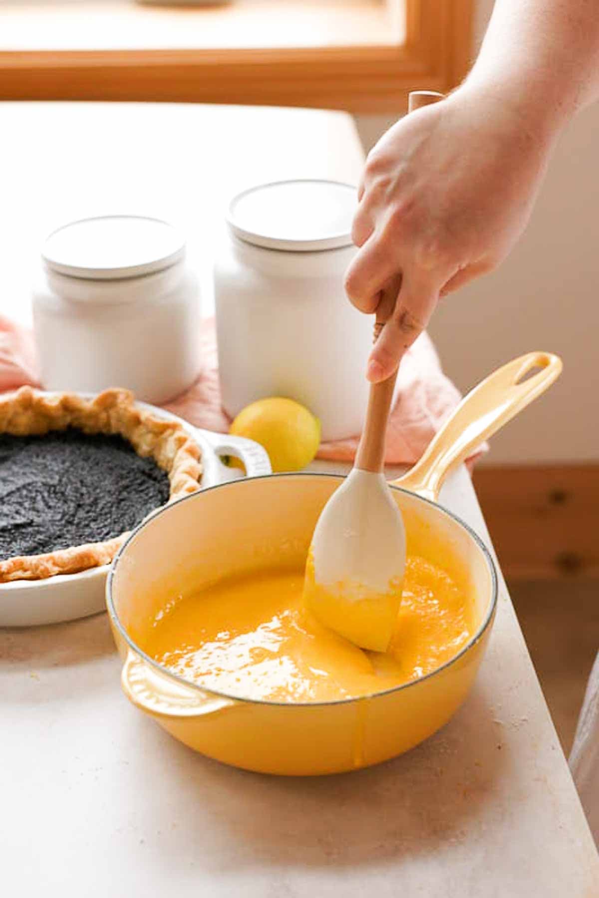 stirring uncooked lemon meringue pie filling in saucepan