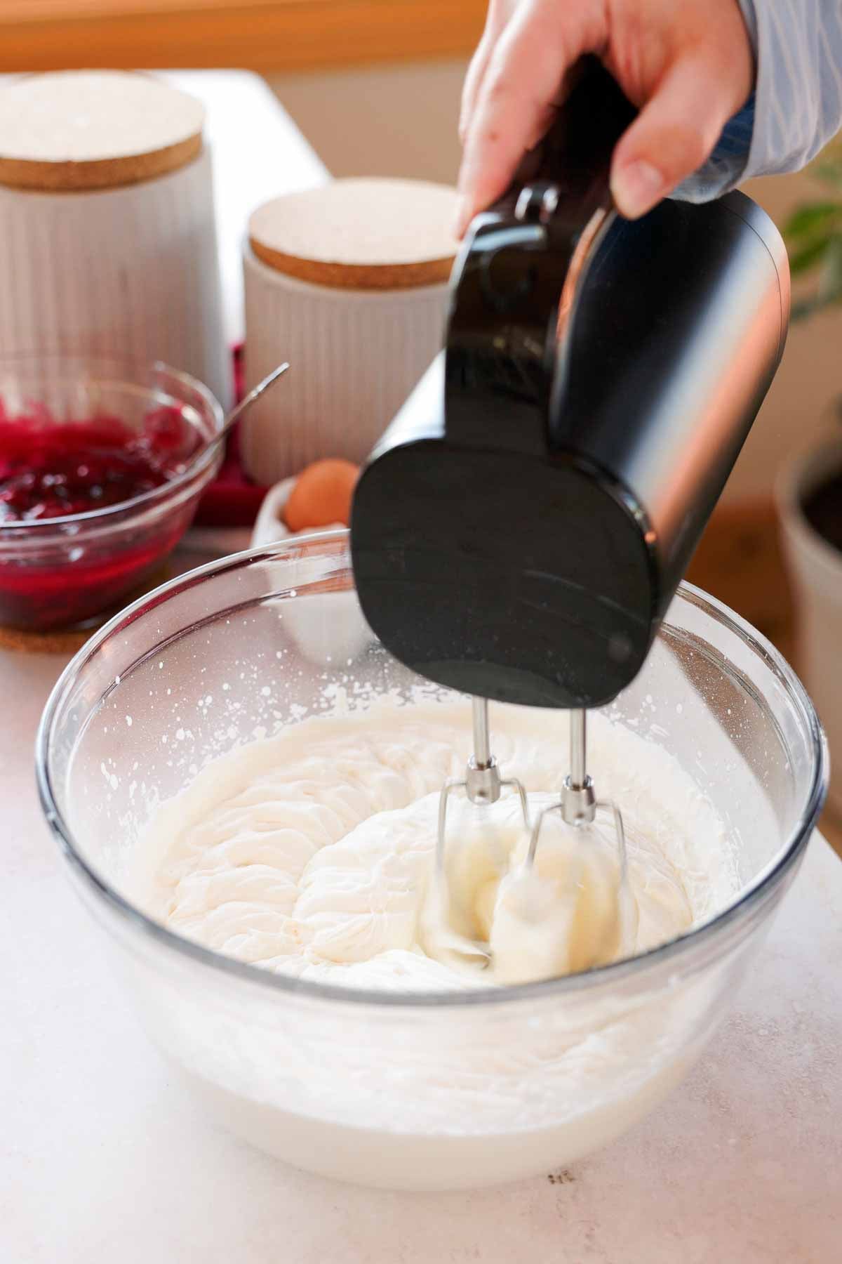 whipping cream to medium stiff peaks in large glass bowl with electric hand mixer
