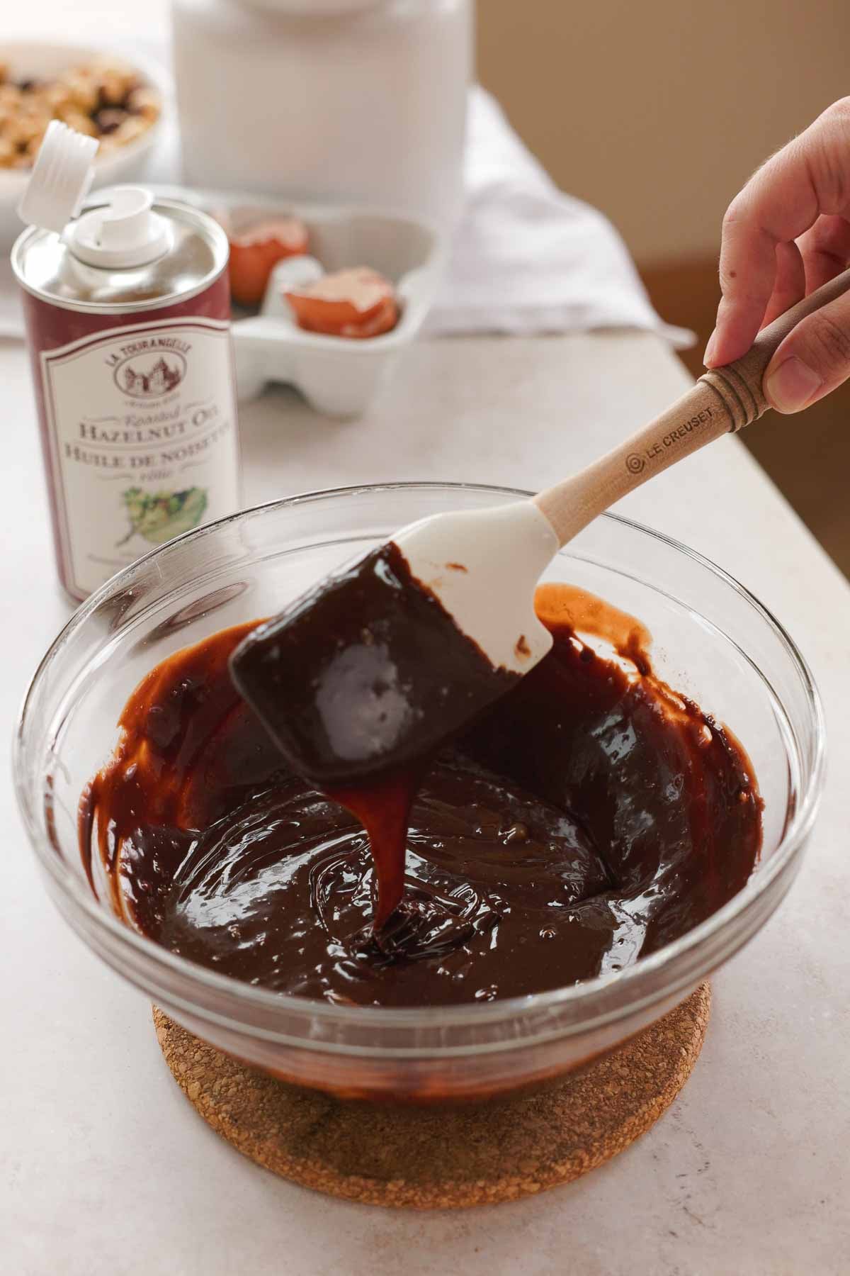 melted chocolate and hazelnut infused cream in large glass bowl
