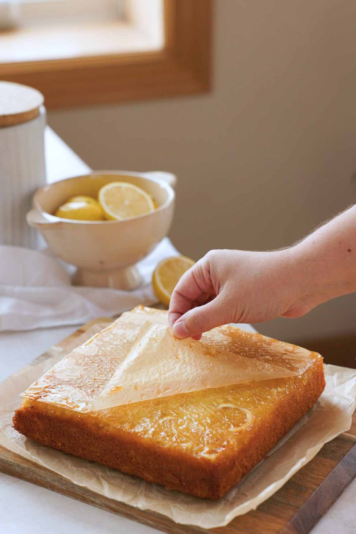 peeling parchment paper off lemon olive oil upside down cake
