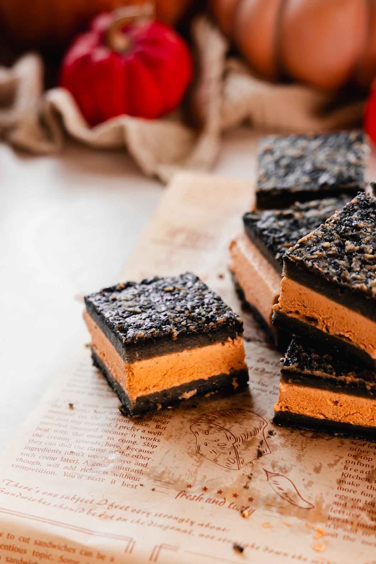 square black sesame butter mochi ice cream sandwich with pumpkin ice cream in the center