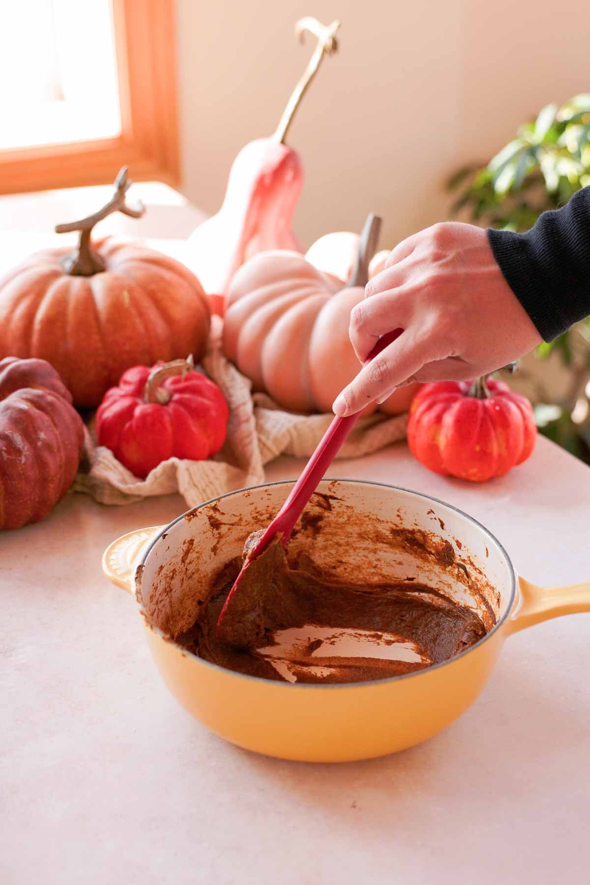 cooking pumpkin down with spices in saucepan