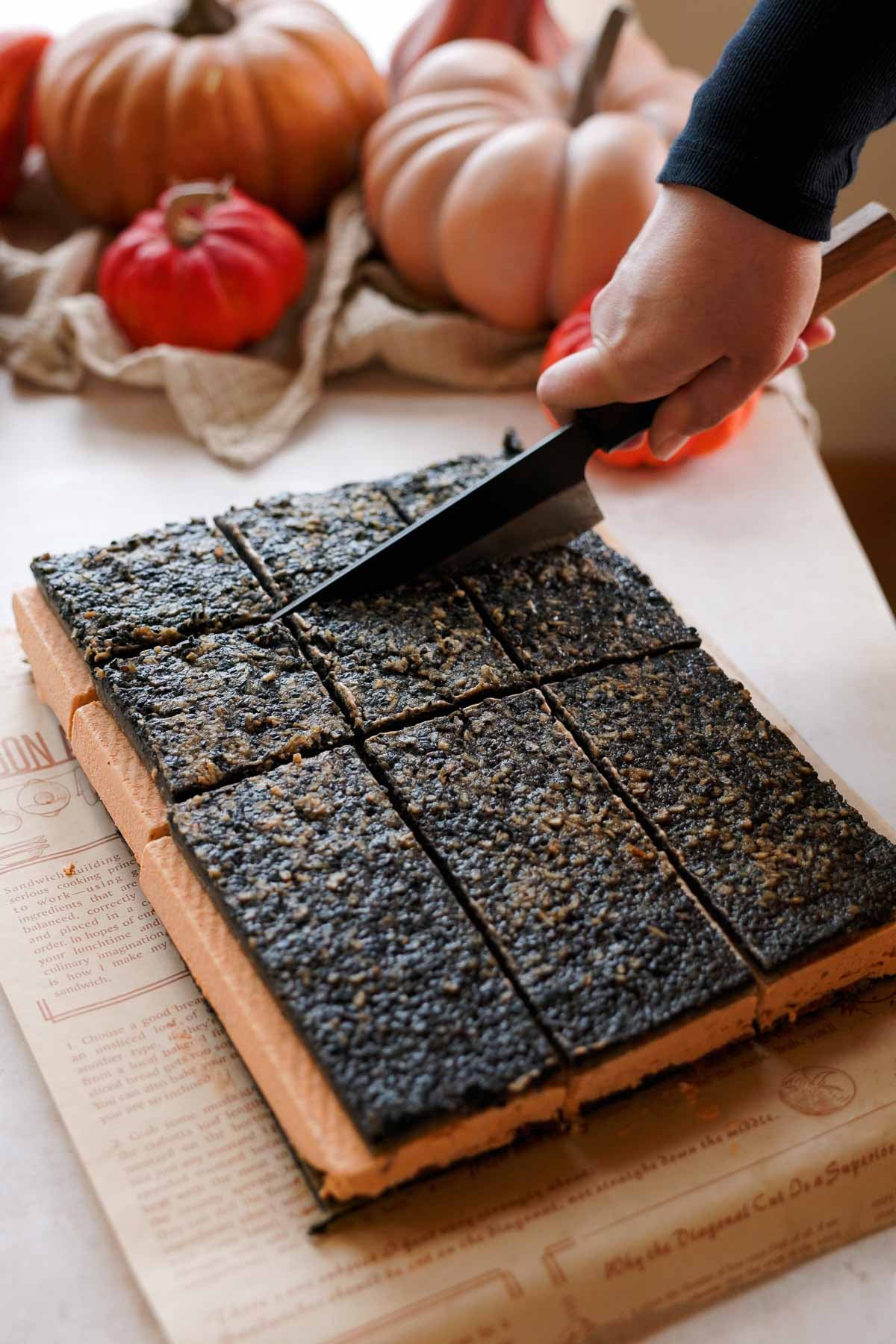 cutting black sesame pumpkin ice cream sandwiches into squares