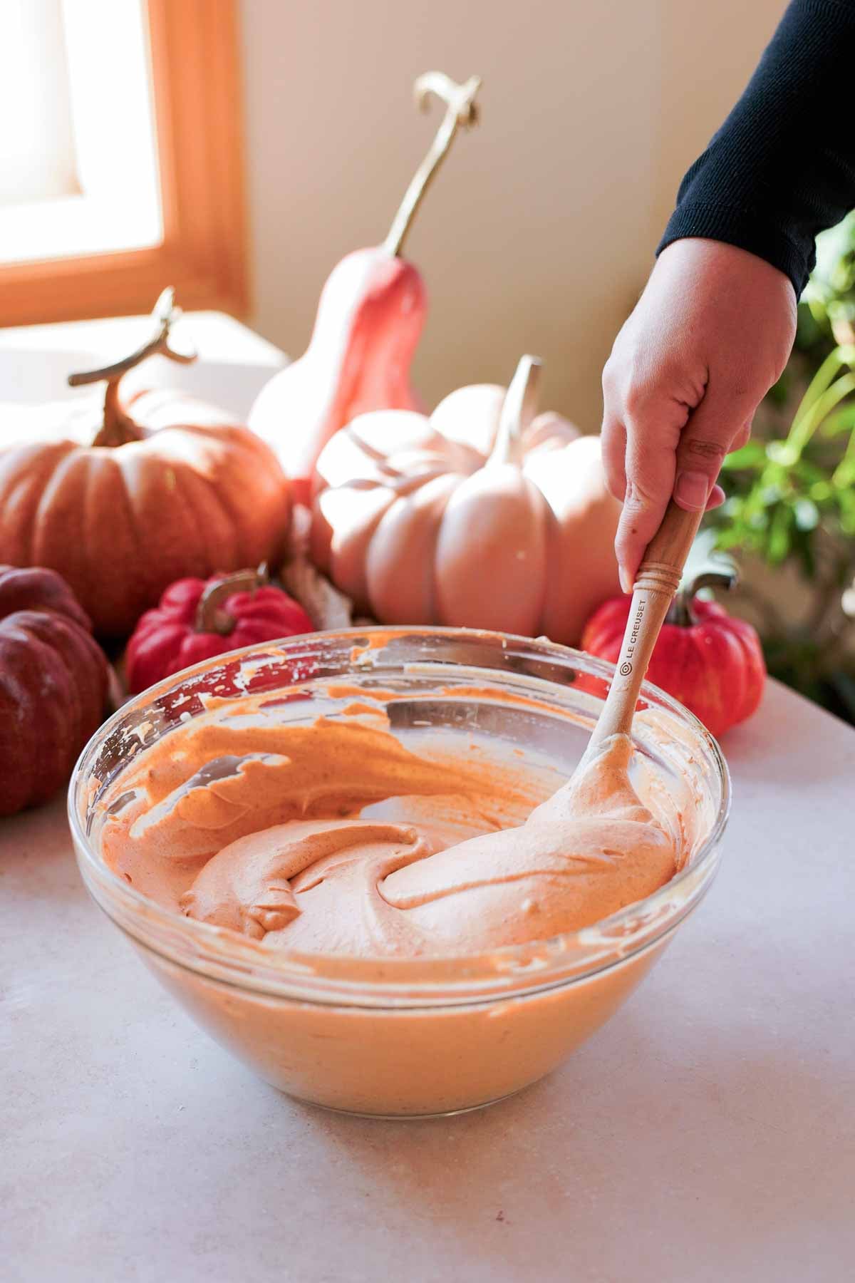 mixing pumpkin spice no churn ice cream with spatula